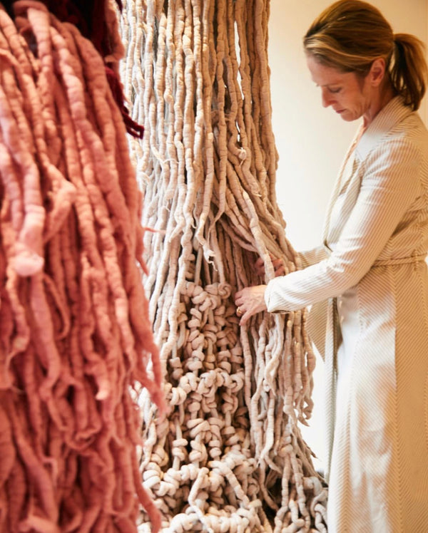 Image of Jacqui Fink working on an installation in the store of Gabriella Hearst in  New York, USA