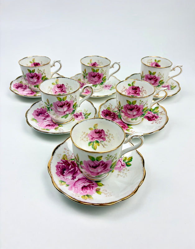 Set of 6 ceramic tea cups and saucers with floral design on a white background
