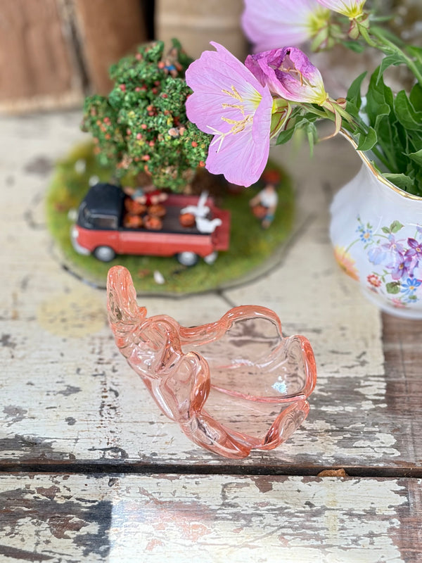 Rosaline pink pressed-glass cornucopia salt cellar styled on a vintage timber tabletop among shells, crystals and collected objects